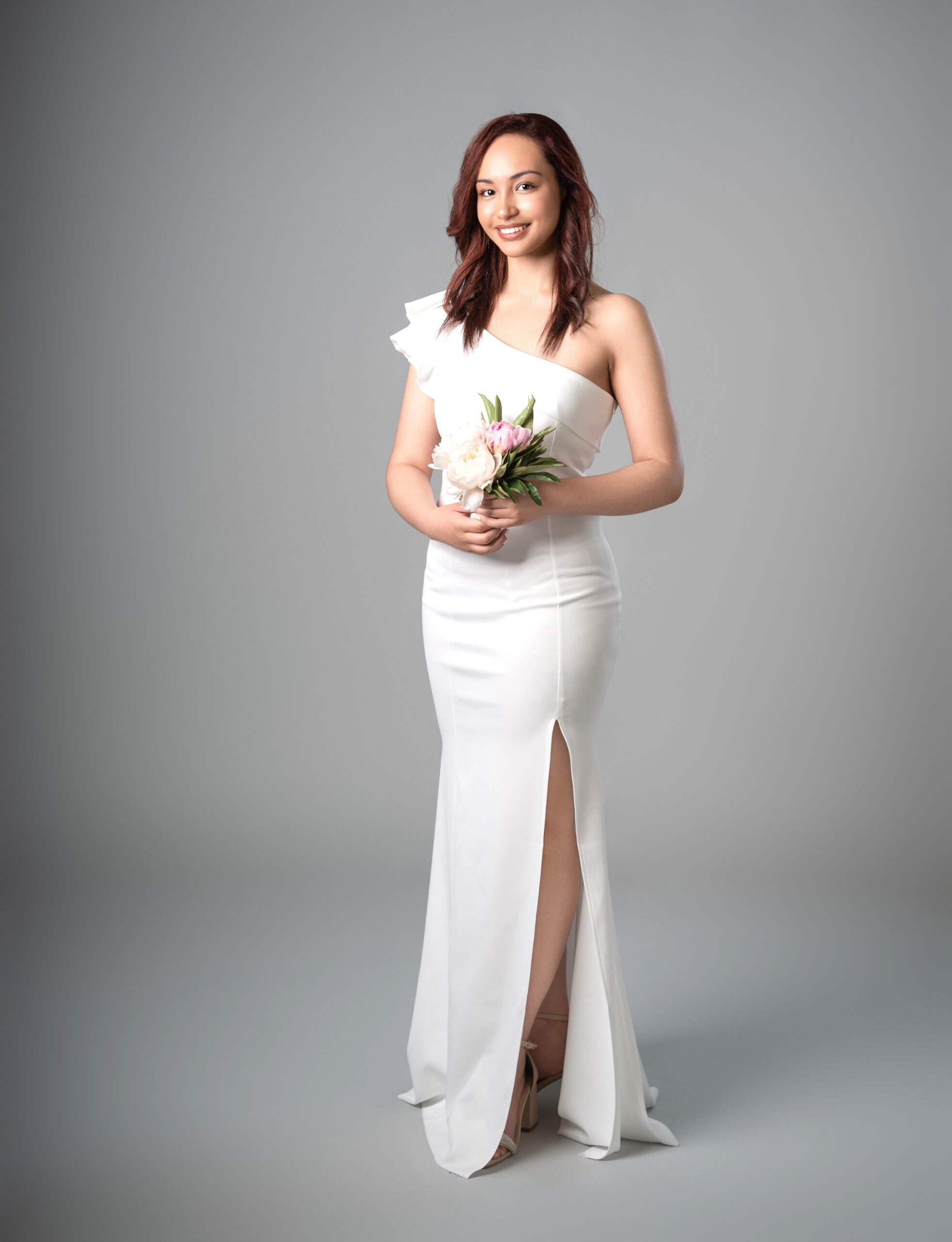 White one-shoulder ruffle mermaid dress with fitted bodice and graceful front leg slit