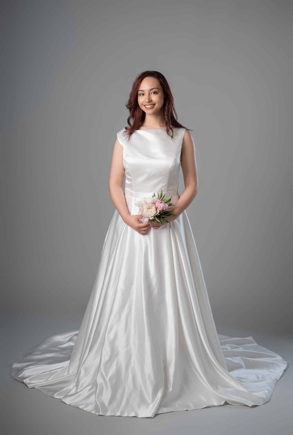 Model in white satin boat neckline A-line wedding dress with sweep train, front view – Art Kollocsion Auckland