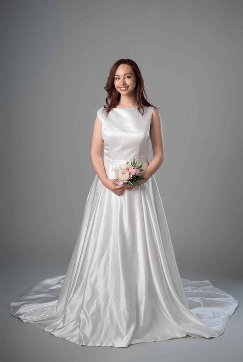 Model in white satin boat neckline A-line wedding dress with sweep train, front view – Art Kollocsion Auckland