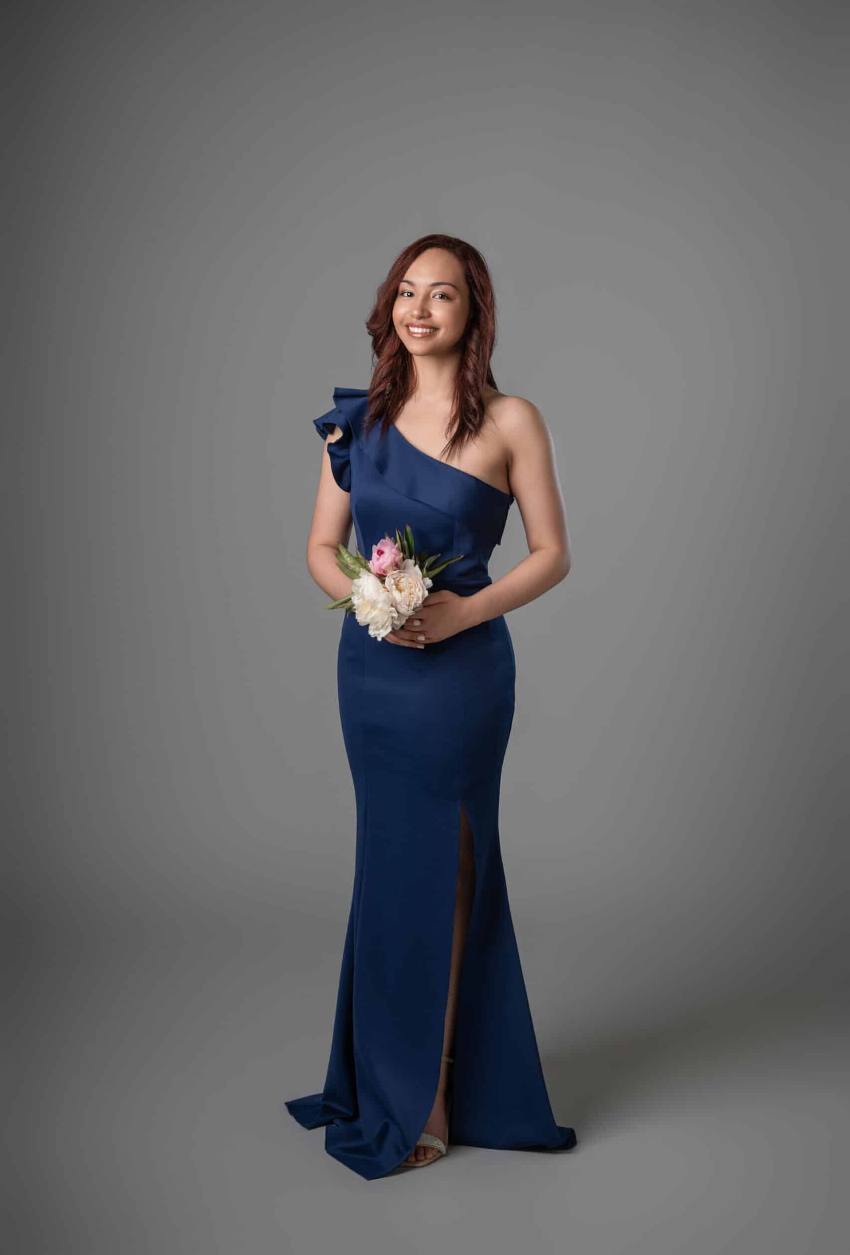 Navy one-shoulder ruffle formal gown with mermaid silhouette and front leg opening detail