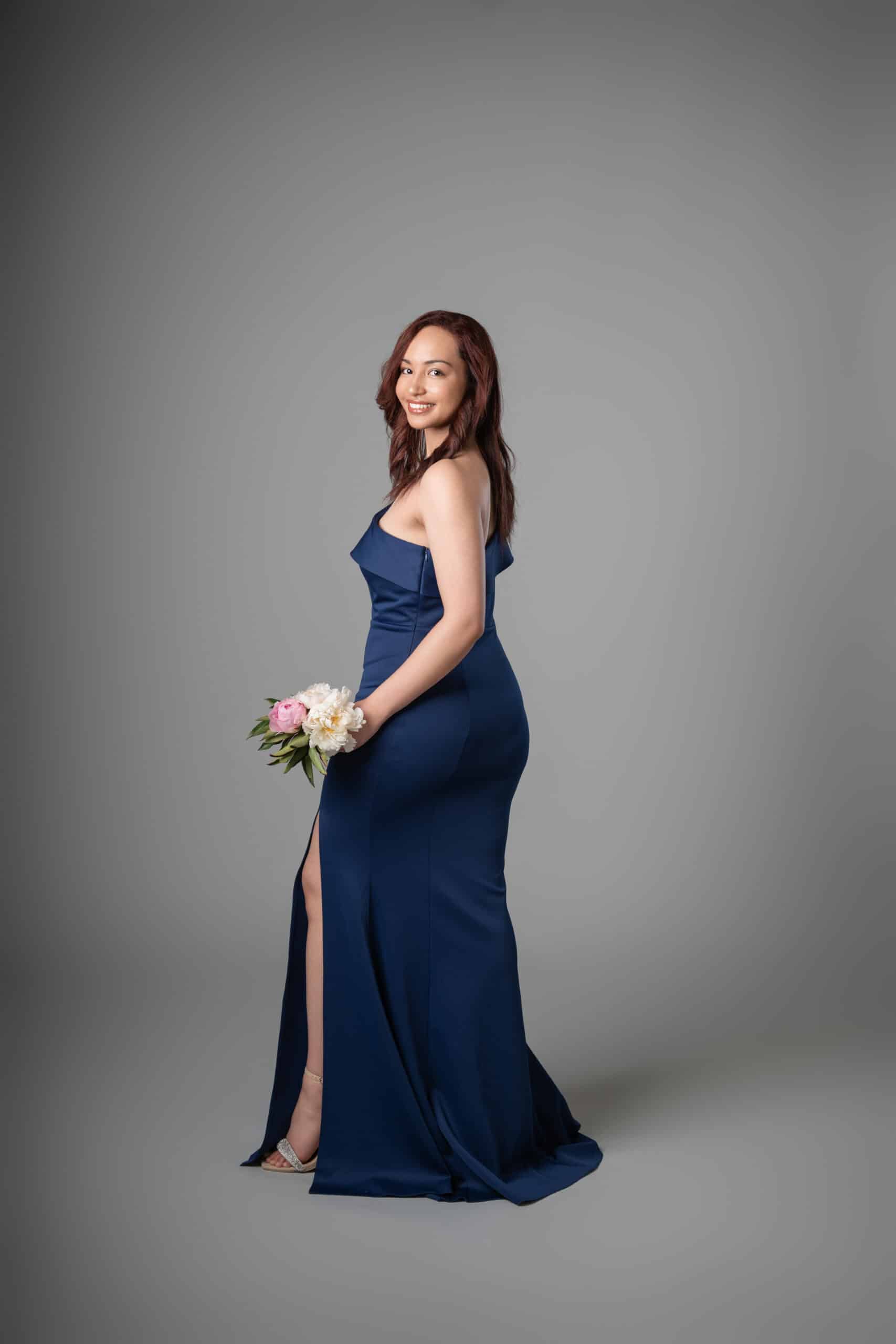 Back view of navy one-shoulder ruffle mermaid formal dress with dramatic train