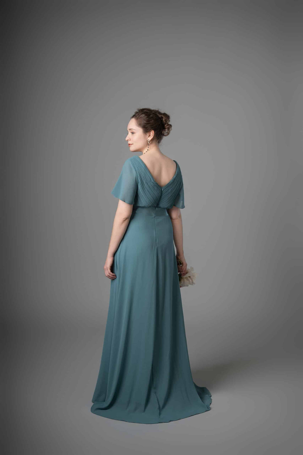 Teal chiffon bridesmaids dress back view showing V-neckline and cascading drapes