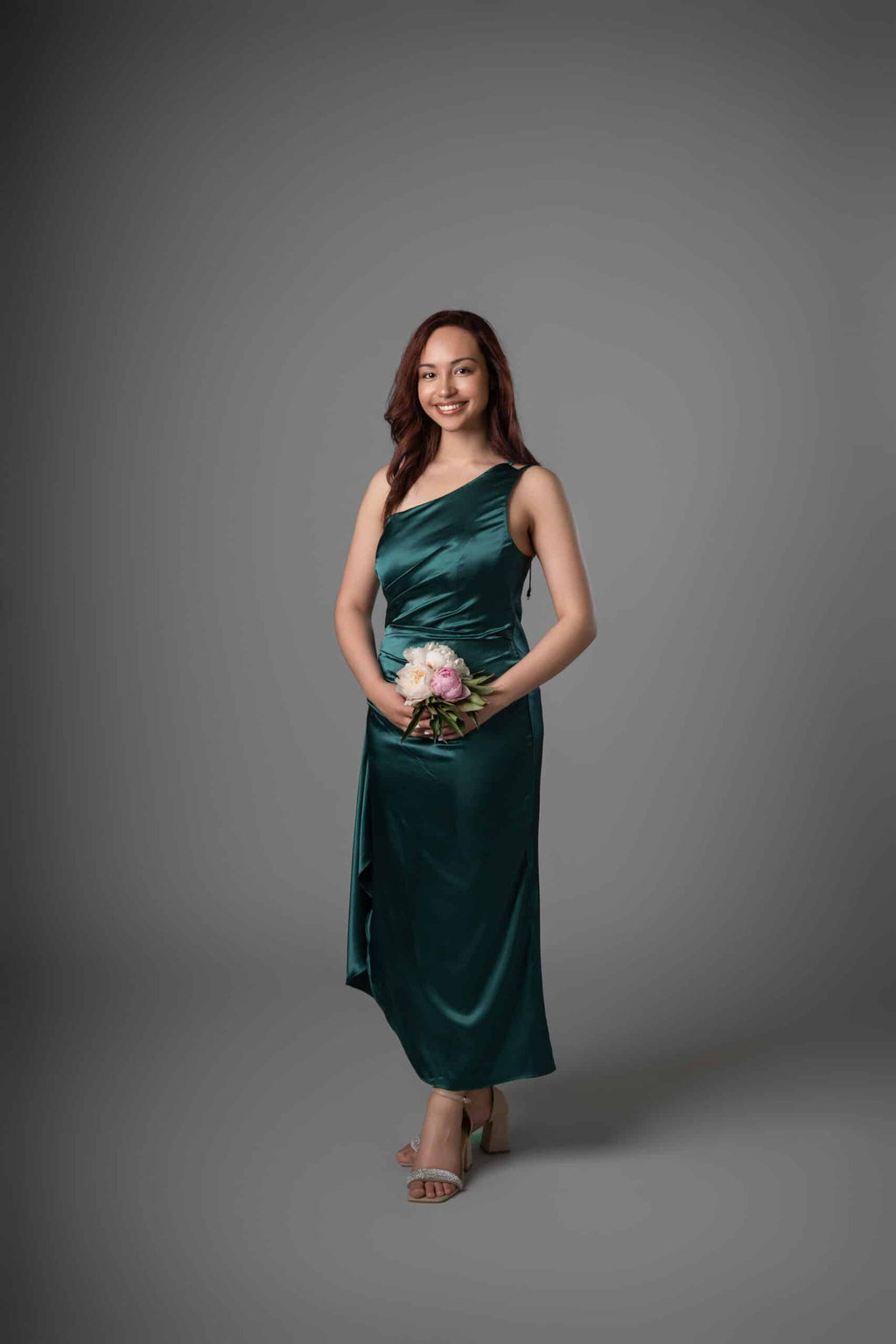 Deep emerald satin one-shoulder bridesmaids gown with elegant draped bodice