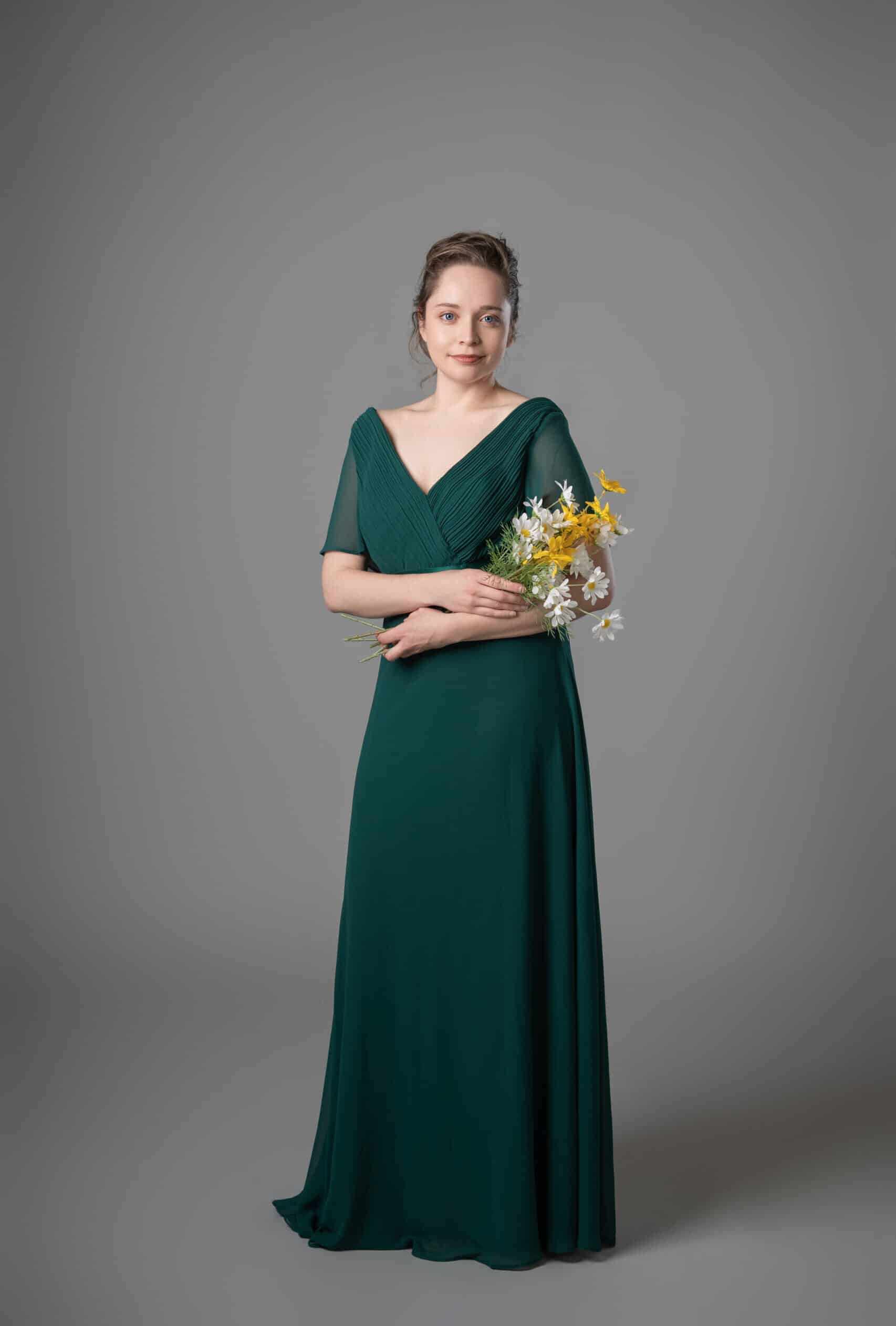 Emerald green chiffon bridesmaids dress with pleated V-neck and sheer flutter sleeves, front view – Art Kollocsion Auckland
