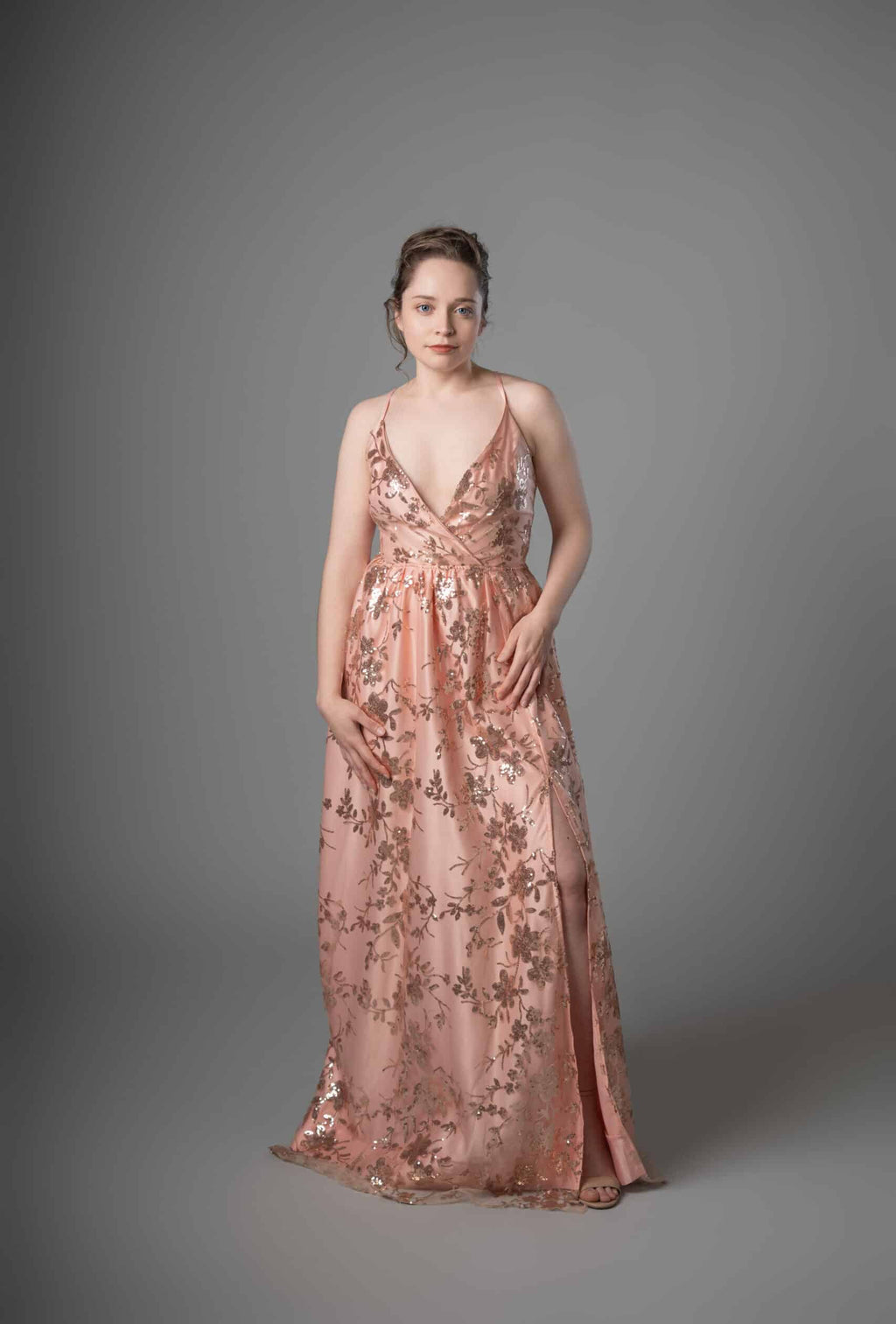 Front view of peach gold embroidered sequin dress with wrap bodice and floor-length skirt