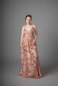 Front view of peach gold embroidered sequin dress with wrap bodice and floor-length skirt