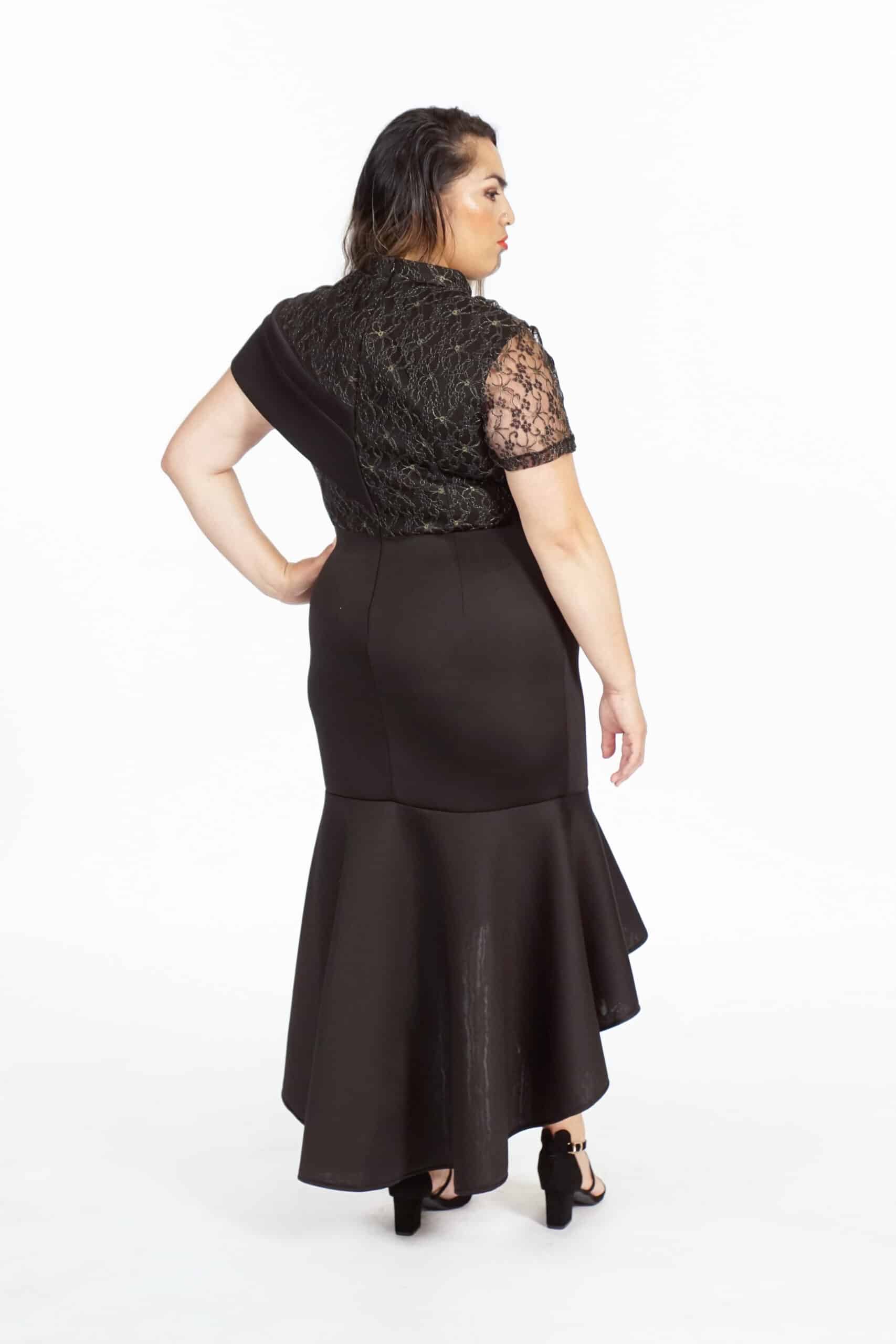 Back view of black formal dress showing lace detailing and flared ruffled hem
