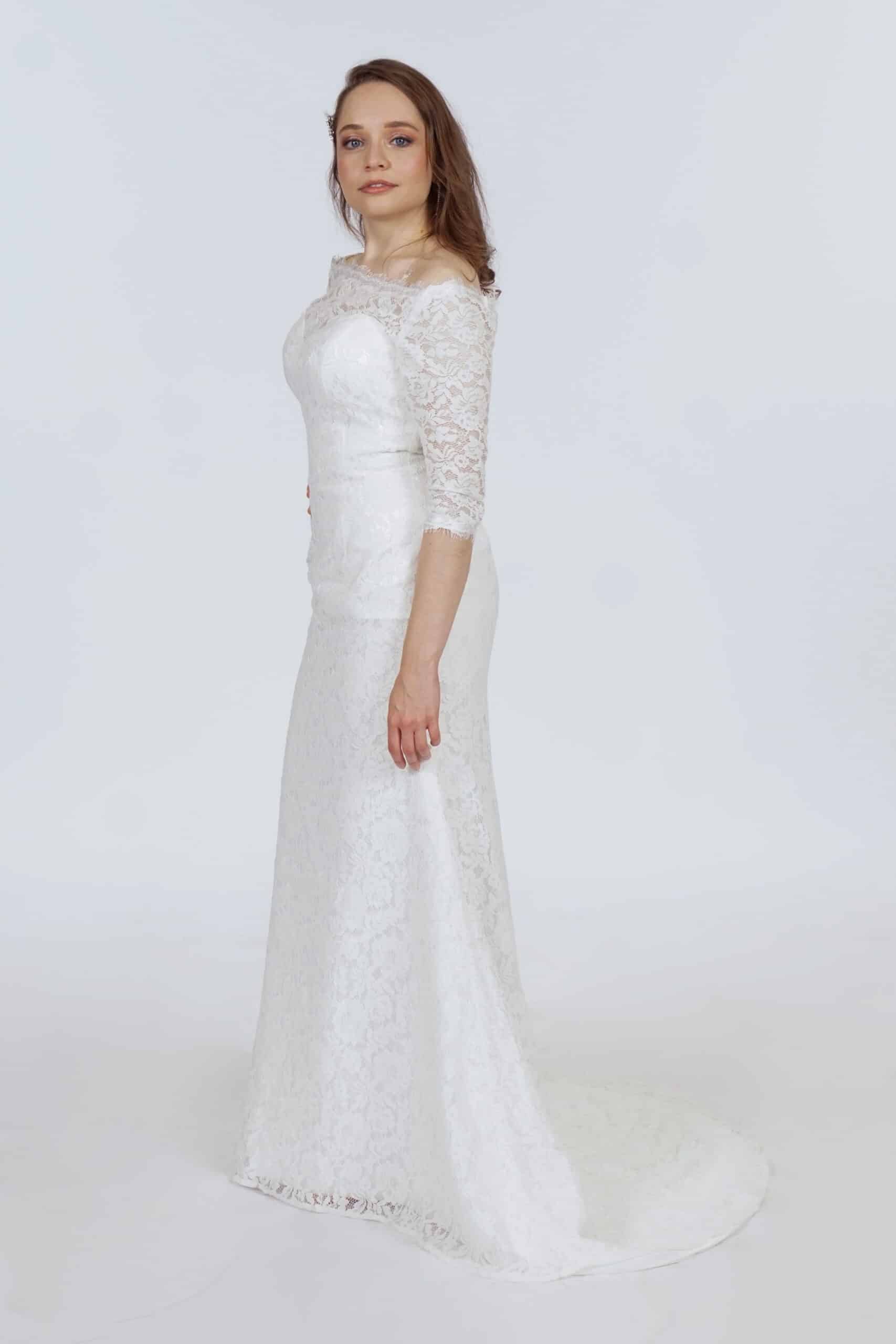 Ivory guipure lace three-quarter sleeve wedding dress with fitted bodice and flowing train – Art Kollocsion