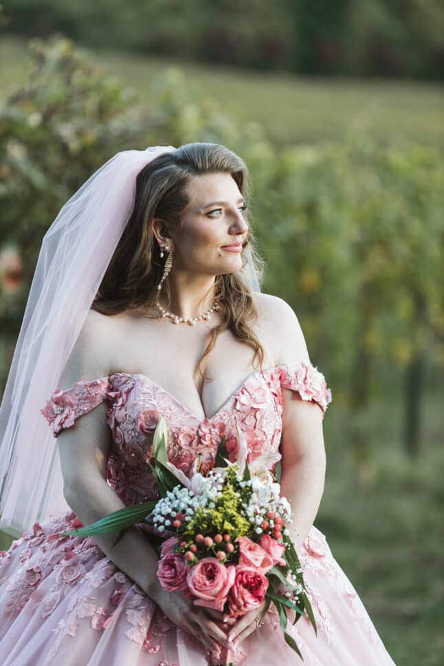 Bride in pink off-shoulder fairytale wedding gown with 3D floral appliqué and veil – Art Kollocsion Auckland