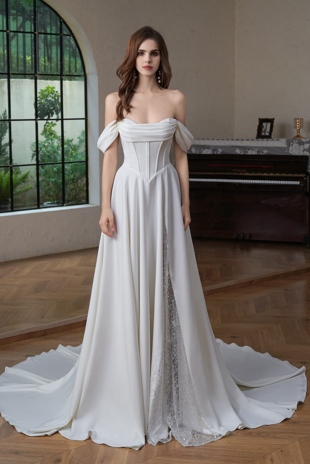 Front view of ivory A-line off shoulder bridal gown with split skirt revealing beaded lace – Art Kollocsion Auckland