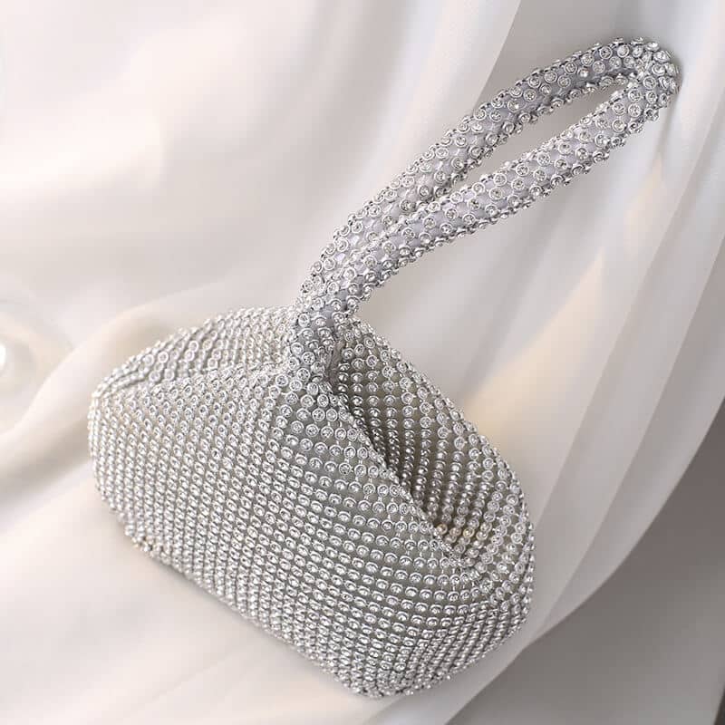 Close-up of rhinestone-studded handle and structured bag body showing intricate beading