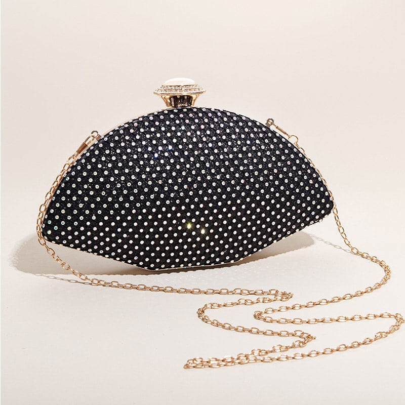 Black rhinestone clutch with white crystal embellishments and gold chain strap