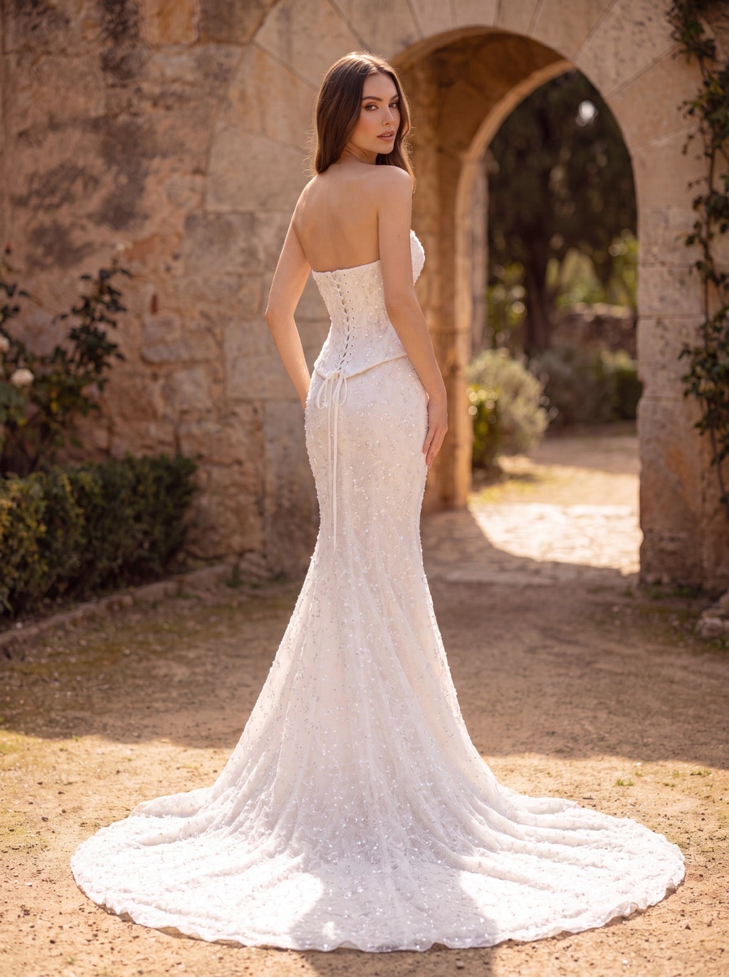 Backing image of Ivory beaded mermaid wedding dress with sweetheart neckline, floral lace and long cathedral train, Corset Bodice with backing strapss