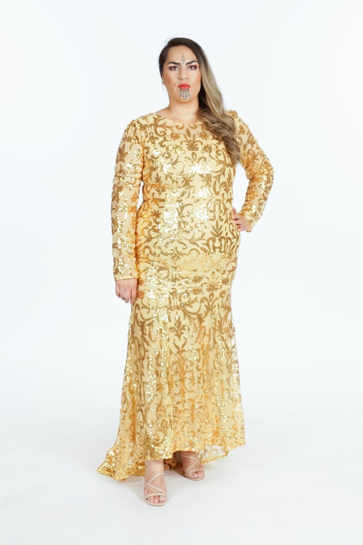 Gold sequin embroidered gown with baroque damask pattern, long sleeves, and flared hem