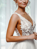 Side close-up of custom-made gown bodice with sheer lace applique panels and shimmering tulle A-line skirt