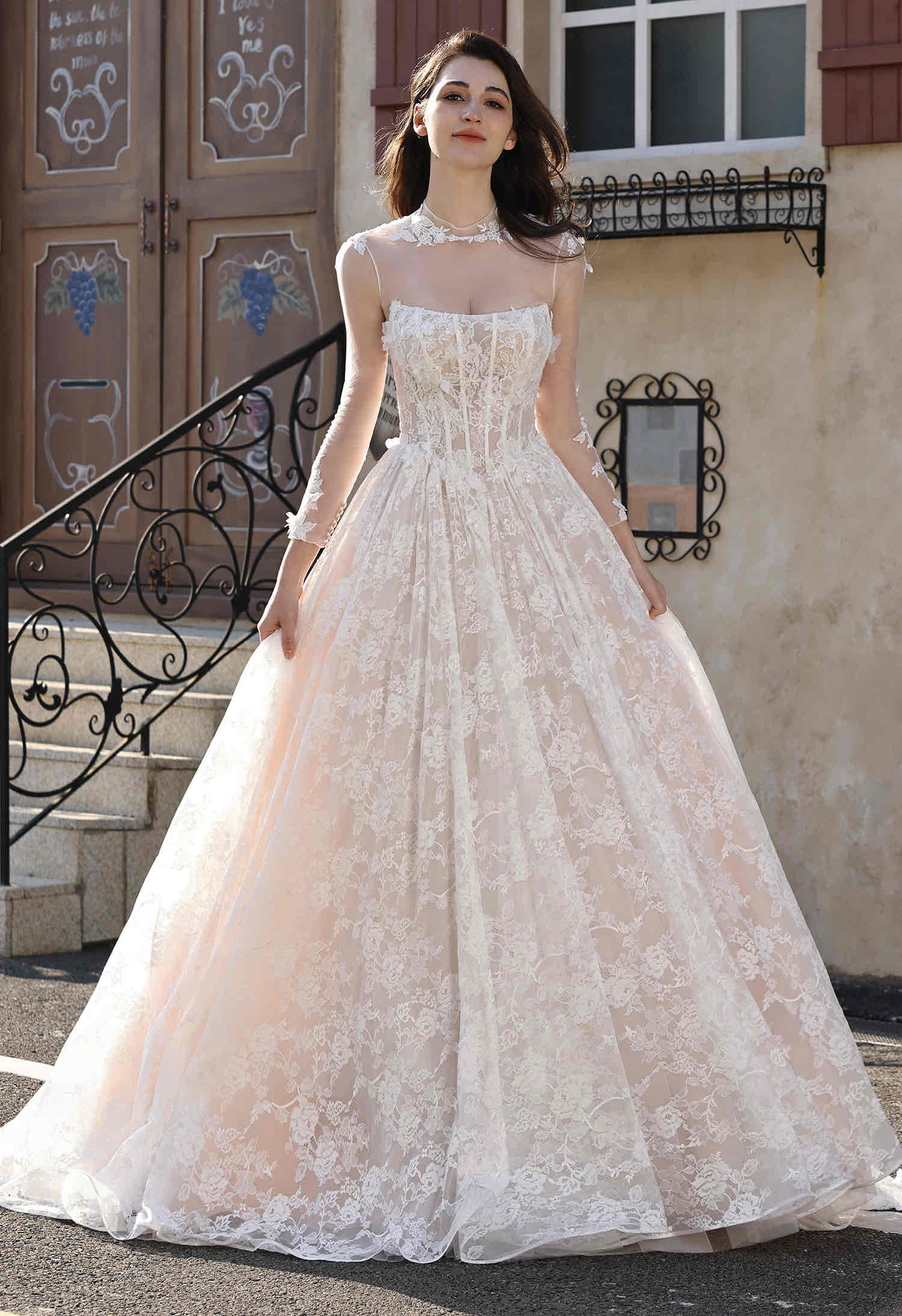 Bride wearing an ivory lace ball gown by Art Kollocsion