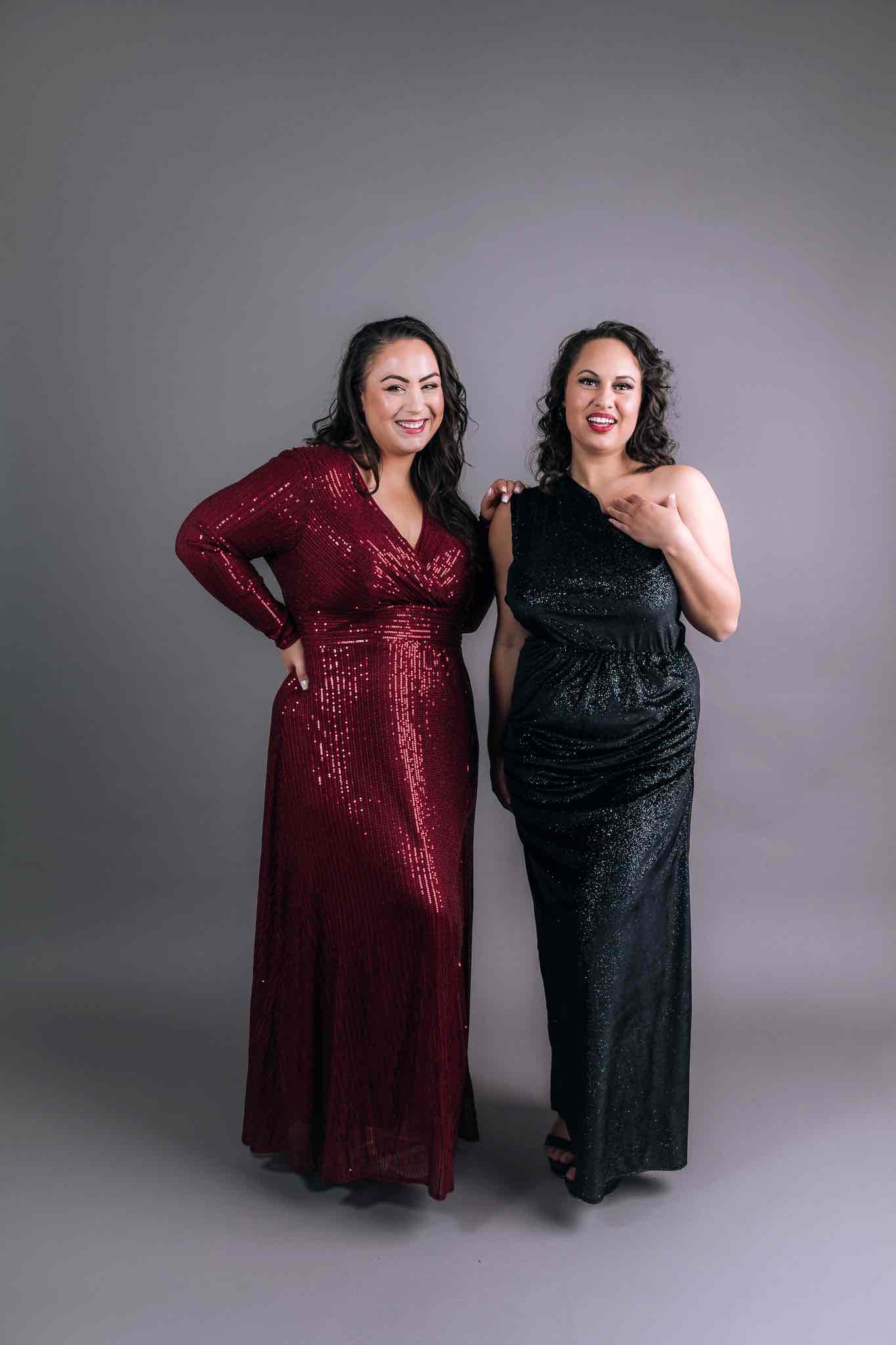 Two bridesmaids in burgundy and black eveningwear by Art Kollocsion