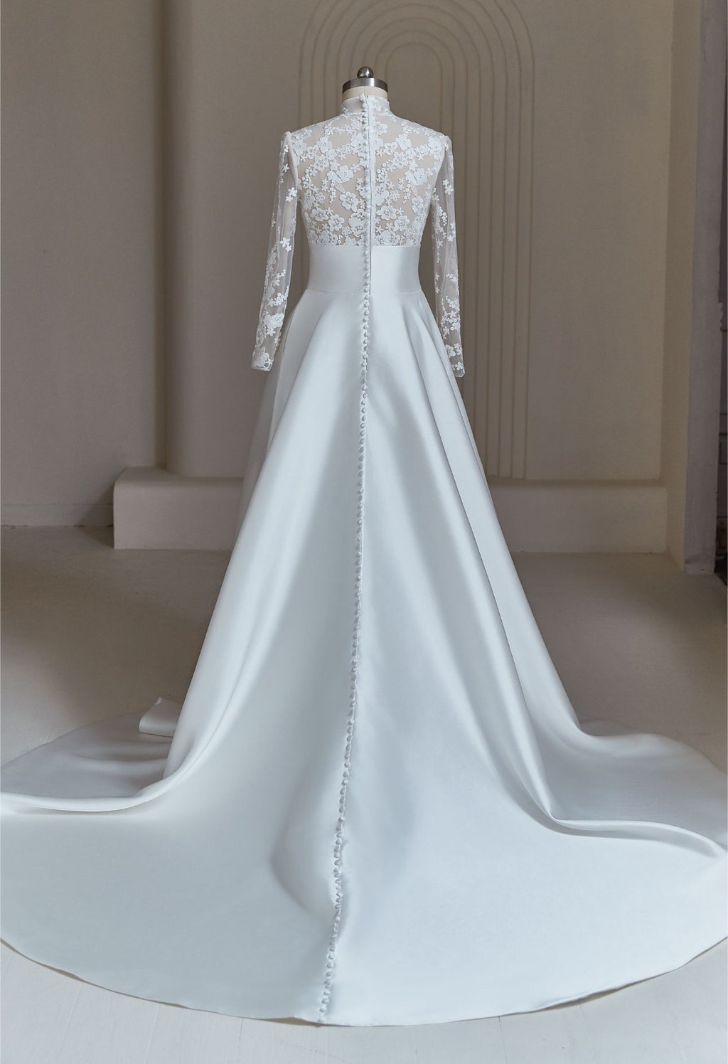 Back view of modest Mikado A-line bridal gown with lace illusion sleeves and buttoned court train