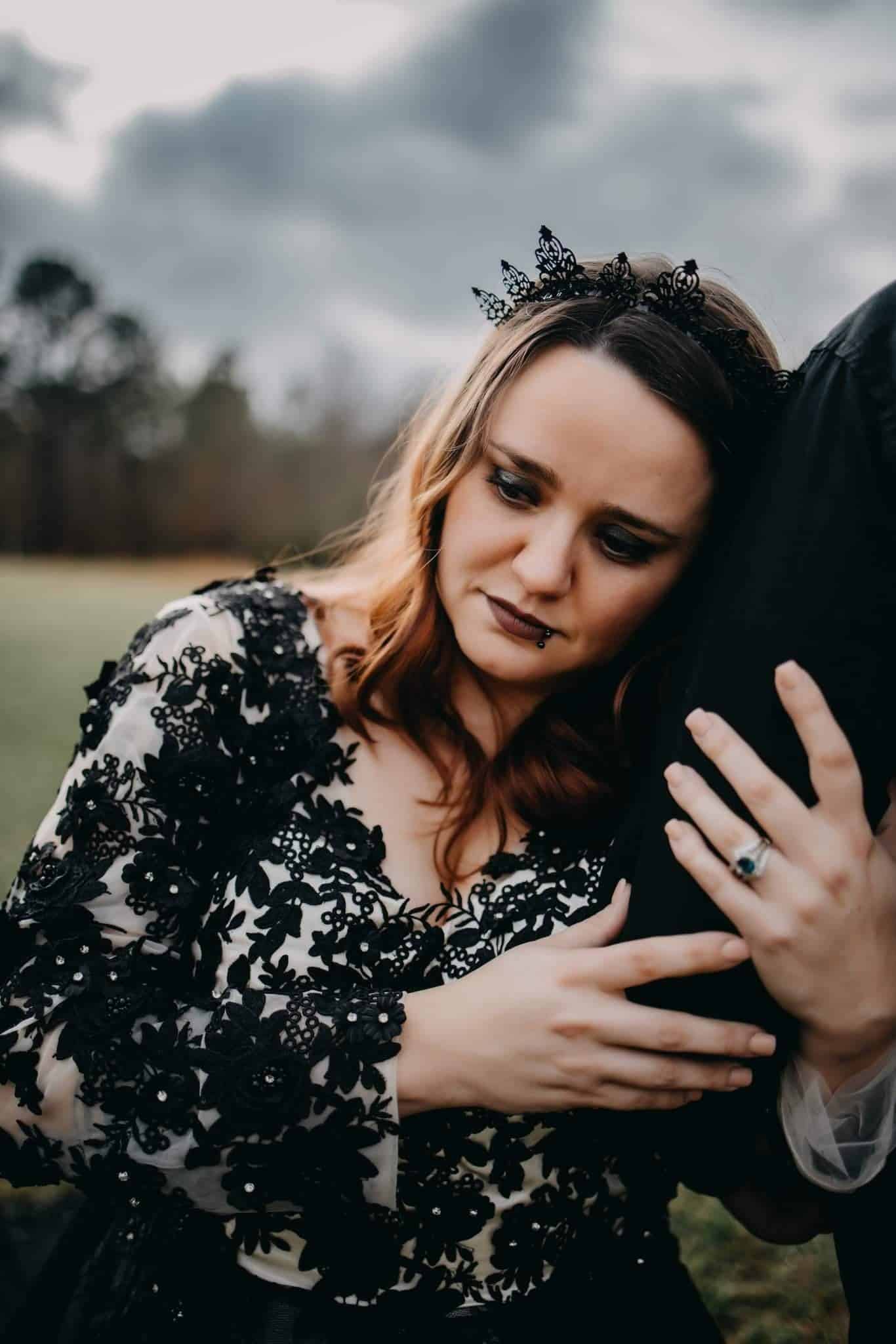 Close-up of beaded black floral lace bodice and long embellished sleeves on Gothic wedding dress