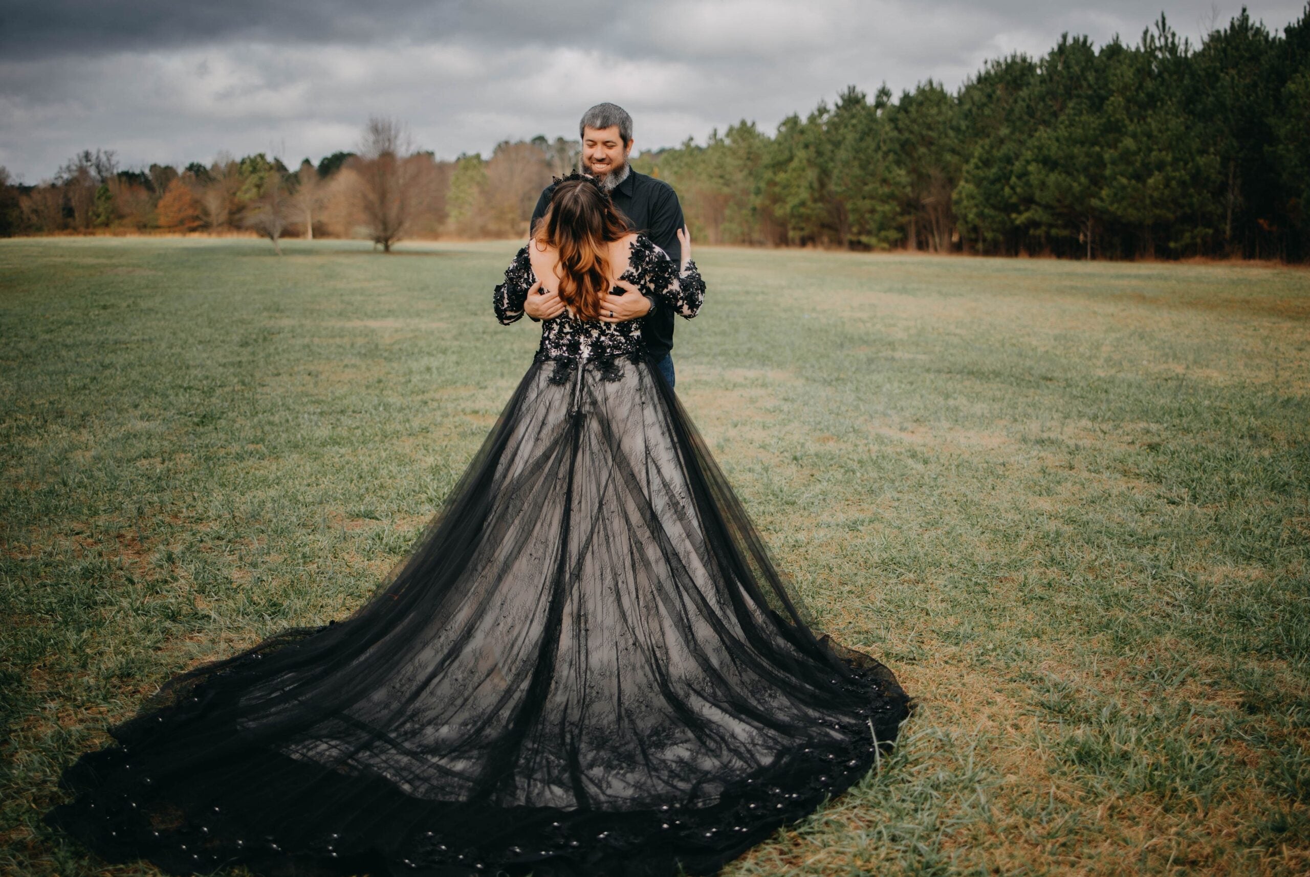 Model wearing black Gothic wedding dress with beaded floral bodice and dramatic tulle train – Art Kollocsion