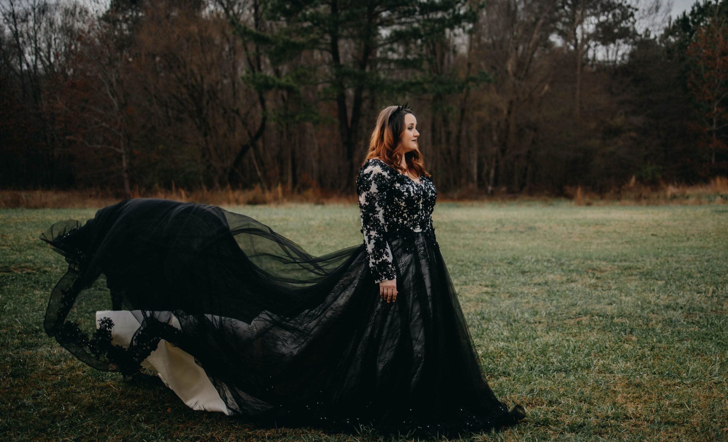 Side profile of Gothic bridal gown with sequined long sleeves and flowing black tulle skirt