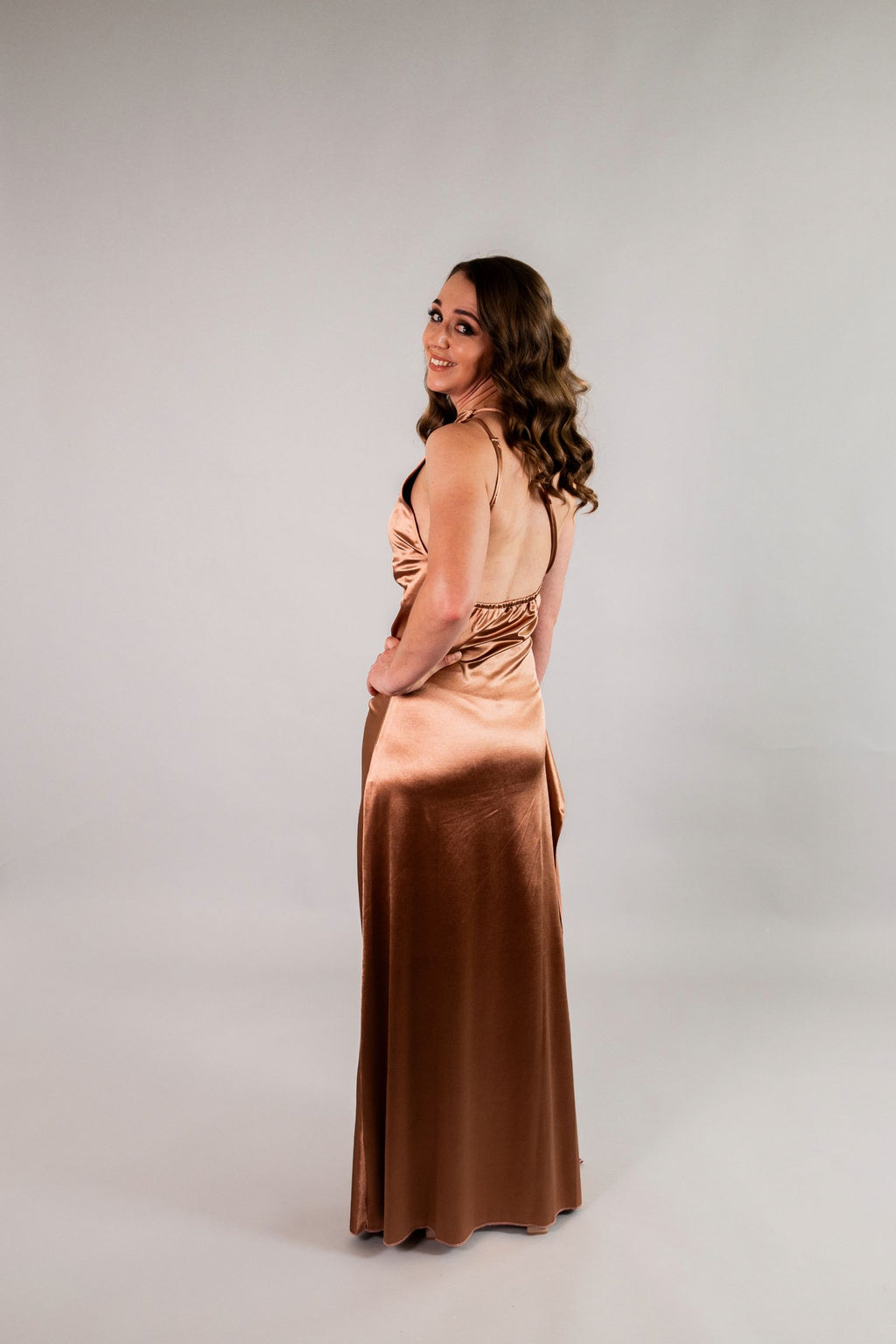 Back view of one-shoulder stretch satin dress with draped open back and ankle-length silhouette