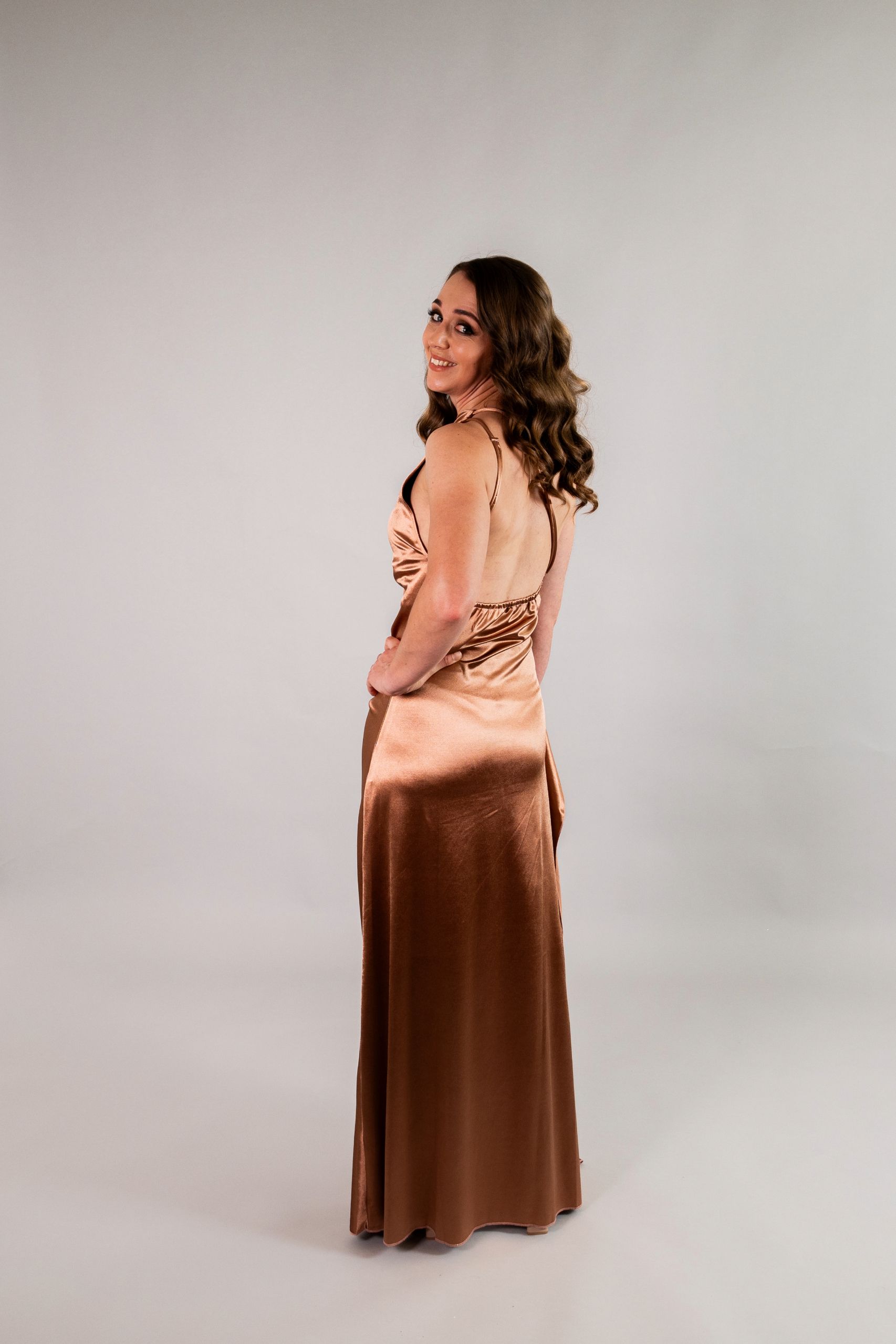Back view of one-shoulder stretch satin dress with draped open back and ankle-length silhouette