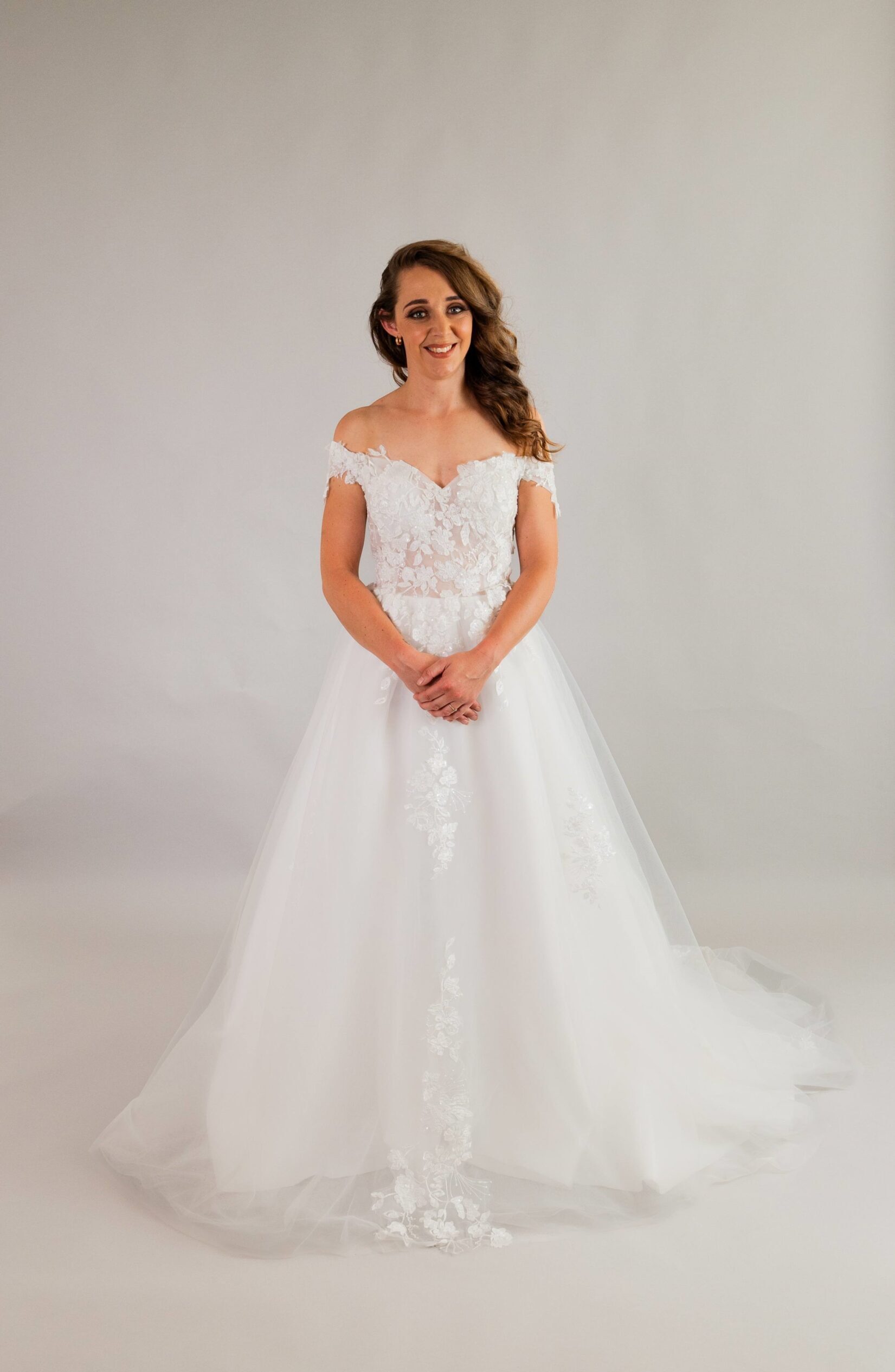 Front view of off-shoulder gown with beaded lace bodice and voluminous tulle skirt