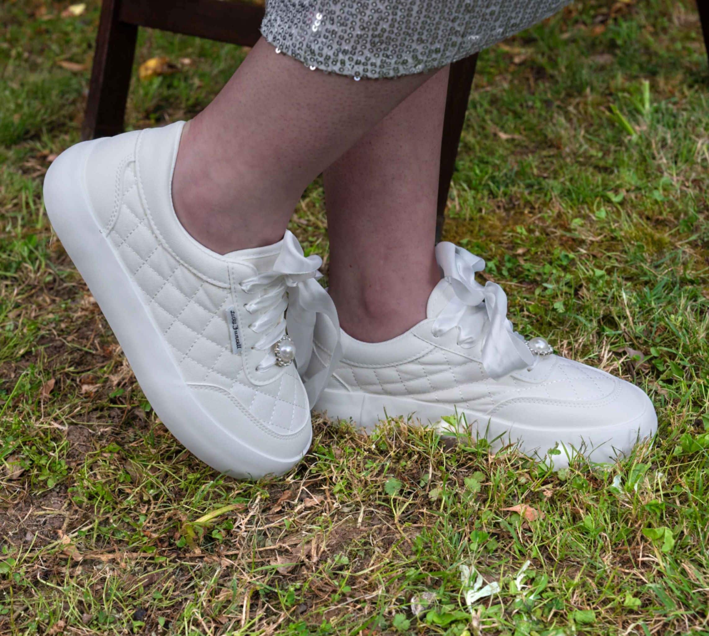 White quilted leather sneakers with lace-up closure worn with bridal gown – Art Kollocsion Auckland