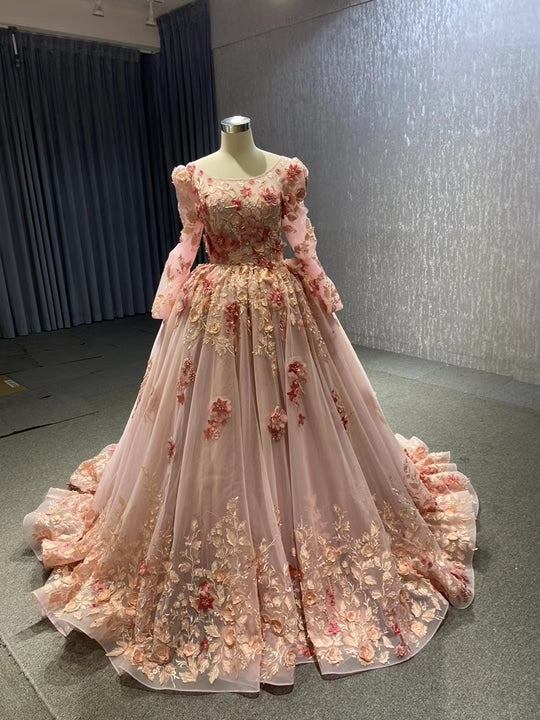 Long-sleeve version of the pink fairytale gown with scoop neckline and gold-pink floral embroidery, front view