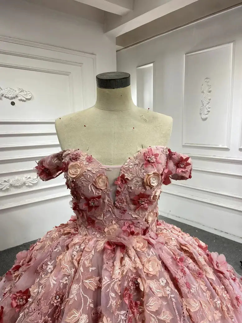 Close-up of off-shoulder sweetheart bodice with 3D floral appliqué on the pink custom fairytale gown