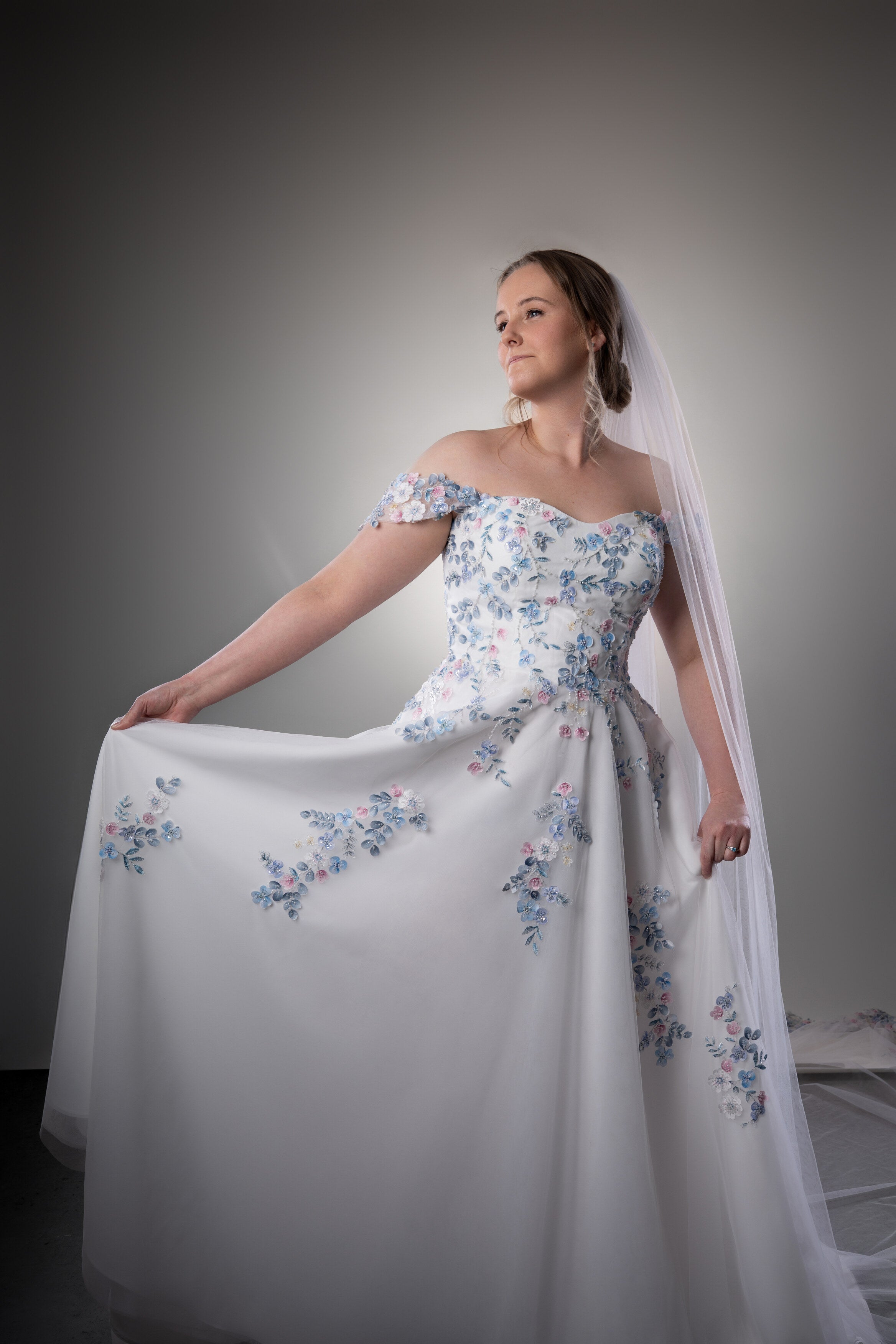 Romantic colourful floral wedding dress with off-shoulder neckline and long cathedral veil in Auckland